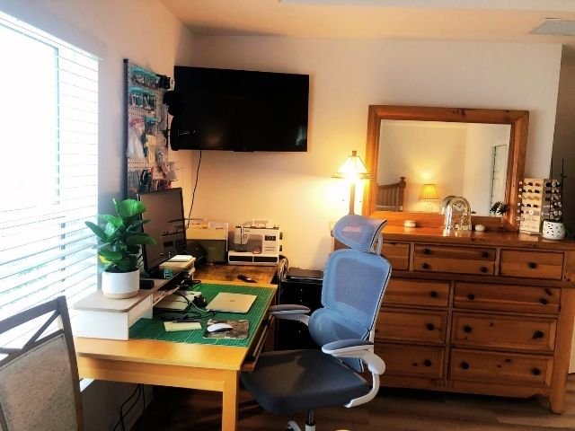 Clean and functional home office desk with dual monitors, organized accessories, and improved lighting after the 12-12-12 declutter method.