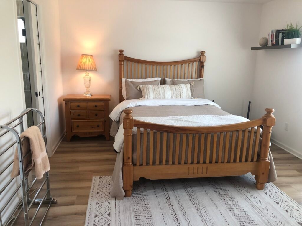 Neat and tidy guest bedroom with a made bed, matching furniture, and a minimalist feel after completing the 12-12-12 declutter challenge.